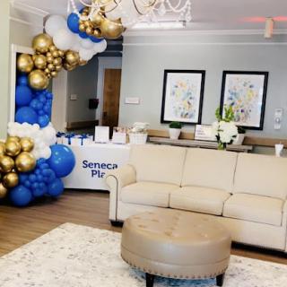 A beautifully decorated lounge area featuring a mix of blue and gold balloons, perfect for celebrations.