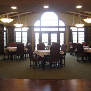 Spacious dining area with large windows and elegant lighting.