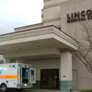 An ambulance parked at the entrance of a medical center.