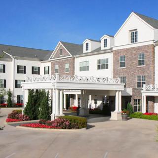 A classic hotel exterior with landscaped entrance.