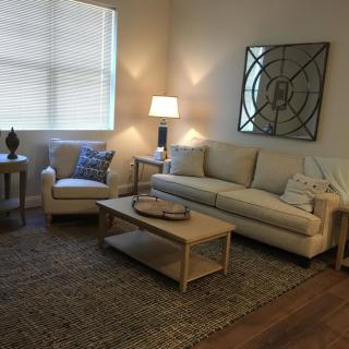 A cozy living room with modern furniture and warm lighting.