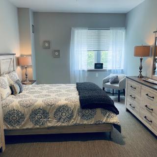 A cozy and elegantly designed bedroom featuring a comfortable bed and stylish furniture.