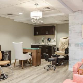 A cozy nail salon interior with manicure and pedicure stations.