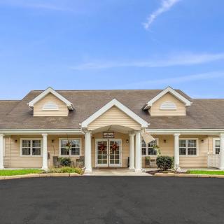 A suburban residential house with a symmetrical front and a well-maintained exterior.
