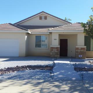 A suburban single-story house with a driveway and garage.
