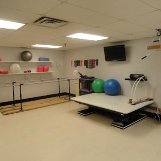 A well-equipped physical therapy room featuring various exercise tools and equipment.