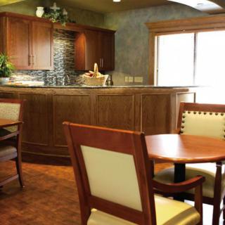 A cozy kitchen and dining area featuring wooden furniture and a countertop.