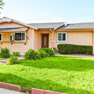 A suburban house with a well-maintained lawn and garden.