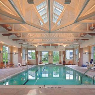 A beautifully designed indoor pool area, featuring high ceilings and ample natural light.