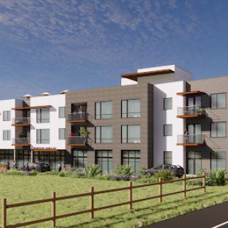 A modern residential building set against a clear blue sky.