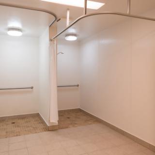 A minimalist interior space with white walls and curved design elements.