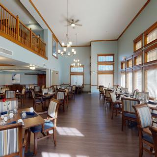 Spacious dining area with elegant chandeliers and abundant natural light.