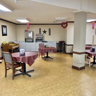 A dining area with tables and chairs decorated for Valentine's Day.