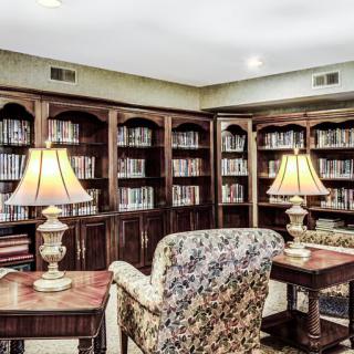 A cozy library corner with bookshelves and comfortable chairs.