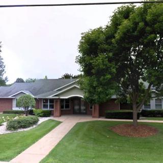 A residential house with a well-maintained lawn and garden.