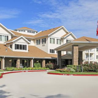 A senior living facility with well-maintained landscaping and a welcoming entrance.
