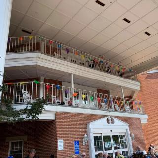 A multi-story building with decorated balconies and a covered entrance.