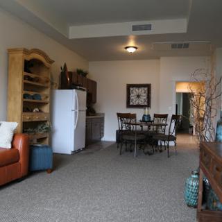A cozy living room featuring a combination of dining and relaxation spaces.