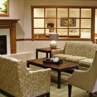 A cozy living room with a sofa set, coffee table, and fireplace.