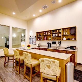 A modern kitchen bar area with elegant seating and ambient lighting.