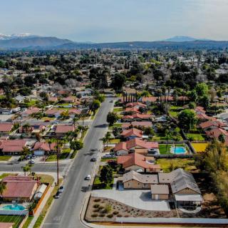 Aerial view of a suburban neighborhood with rows of houses and streets.