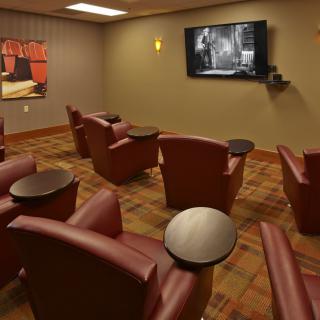 A cozy home theater setup with comfortable seating and a large TV.