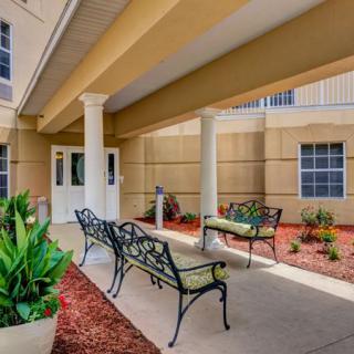 A peaceful outdoor seating area with benches and decorative landscaping.