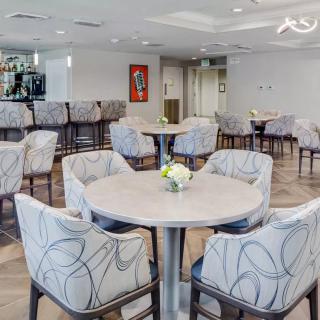 A modern and spacious dining area with neatly arranged tables and chairs.