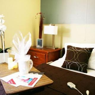 A cozy and well-decorated hotel room with a neatly made bed and stylish decor.