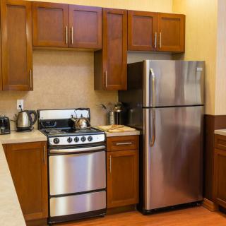 Modern kitchen with stainless steel appliances and wooden cabinets.