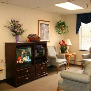 A cozy waiting room with comfortable seating and a television.