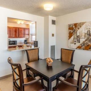 A cozy dining area with a table and chairs, adjacent to a kitchen.