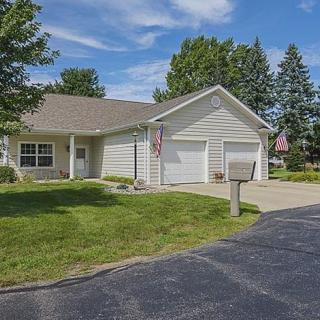 A suburban residential house with a well-maintained lawn and driveway.