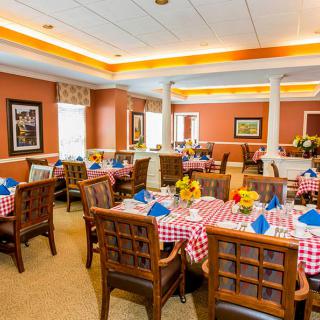A cozy dining room with checkered tablecloths and neatly arranged seating.