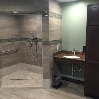 A spacious and modern bathroom featuring a walk-in shower and a stylish sink area.