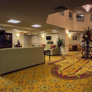 A spacious hotel lobby with comfortable seating and elegant decor.