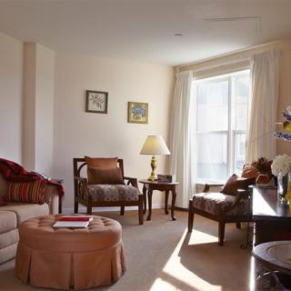 A cozy living room with traditional furniture and abundant natural light.