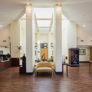 A modern and spacious lobby with bright lighting and elegant furniture.