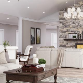 A modern living room with elegant furniture and a stone fireplace.