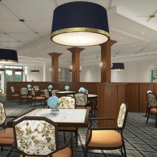A tastefully decorated restaurant interior with elegant lighting and patterned chairs.