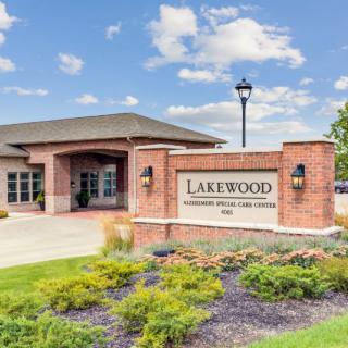 Entrance of Lakewood Community Clubhouse & Sales Center with landscaped surroundings.