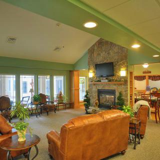 A cozy living room with a fireplace, television, and comfortable seating.
