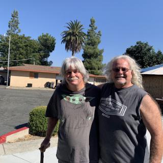 Two friends enjoying a sunny day outdoors.