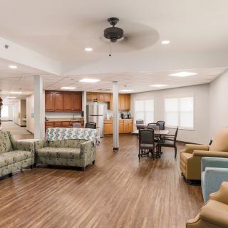 Spacious open floor plan featuring a modern living area and kitchen with hardwood floors.