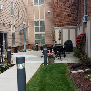 A well-maintained courtyard with outdoor seating in an apartment complex.