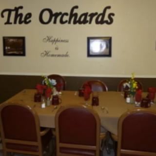 A cozy dining area in The Orchards restaurant with a neatly set table.