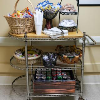 A well-stocked snack cart featuring various treats and beverages.