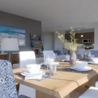 A modern dining room with a stylish table setting and bright, airy decor.