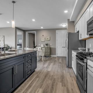 A modern kitchen with stainless steel appliances and a central island.