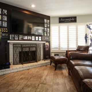 A cozy living room featuring a fireplace and leather furniture.
